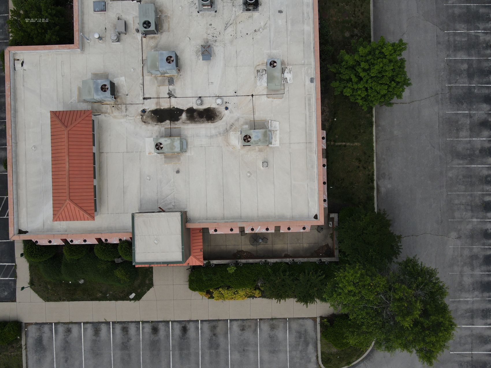 Top-down drone photo of a commercial flat roof with rooftop HVAC units