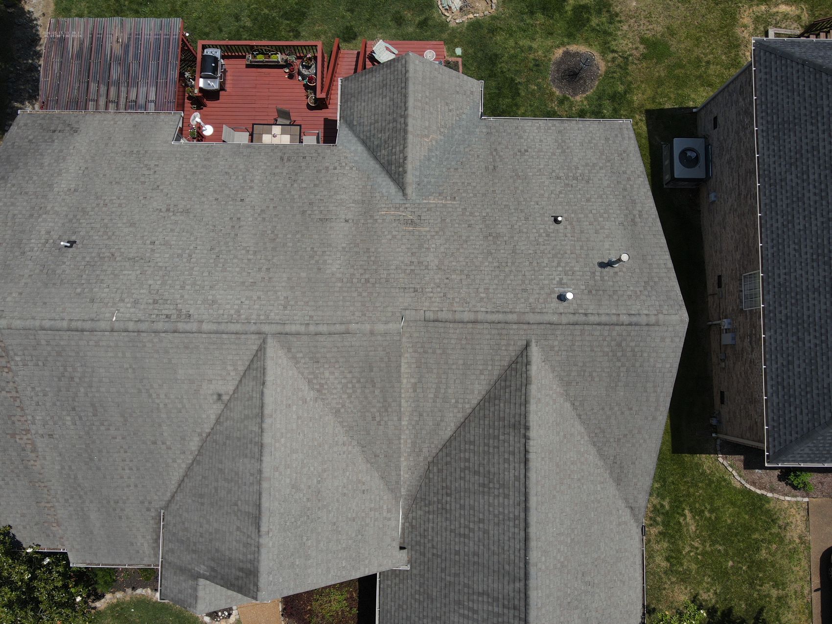 Top-down drone photo of a residential architectural-shingle roof during inspection